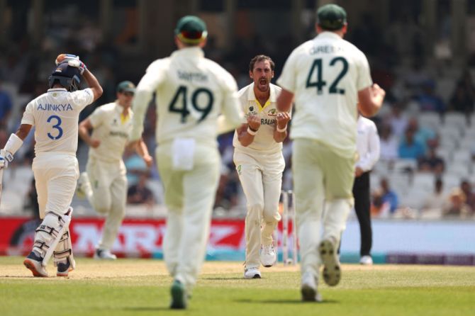 Mitchell Starc celebrates after taking the wicket of Ajinkya Rahane