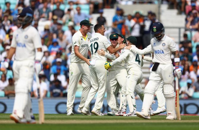 Scott Boland and the Aussies celebrate the wicket of Virat Kohli