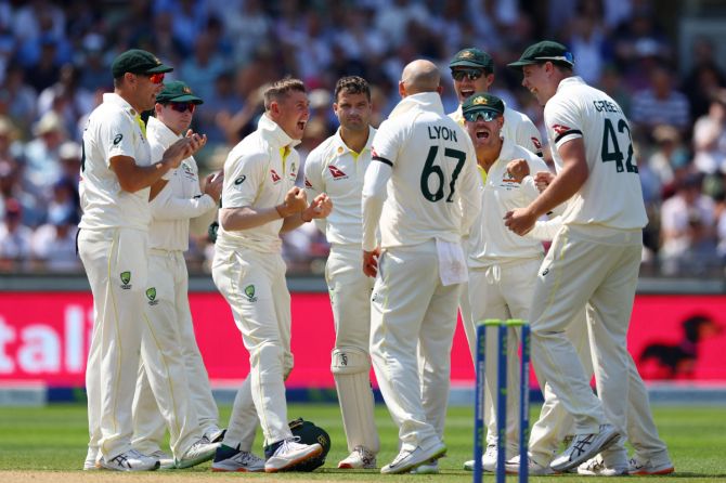 Australia's Nathan Lyon celebrates with teammates after an appeal confirms the lbw wicket of England's Ollie Pope 