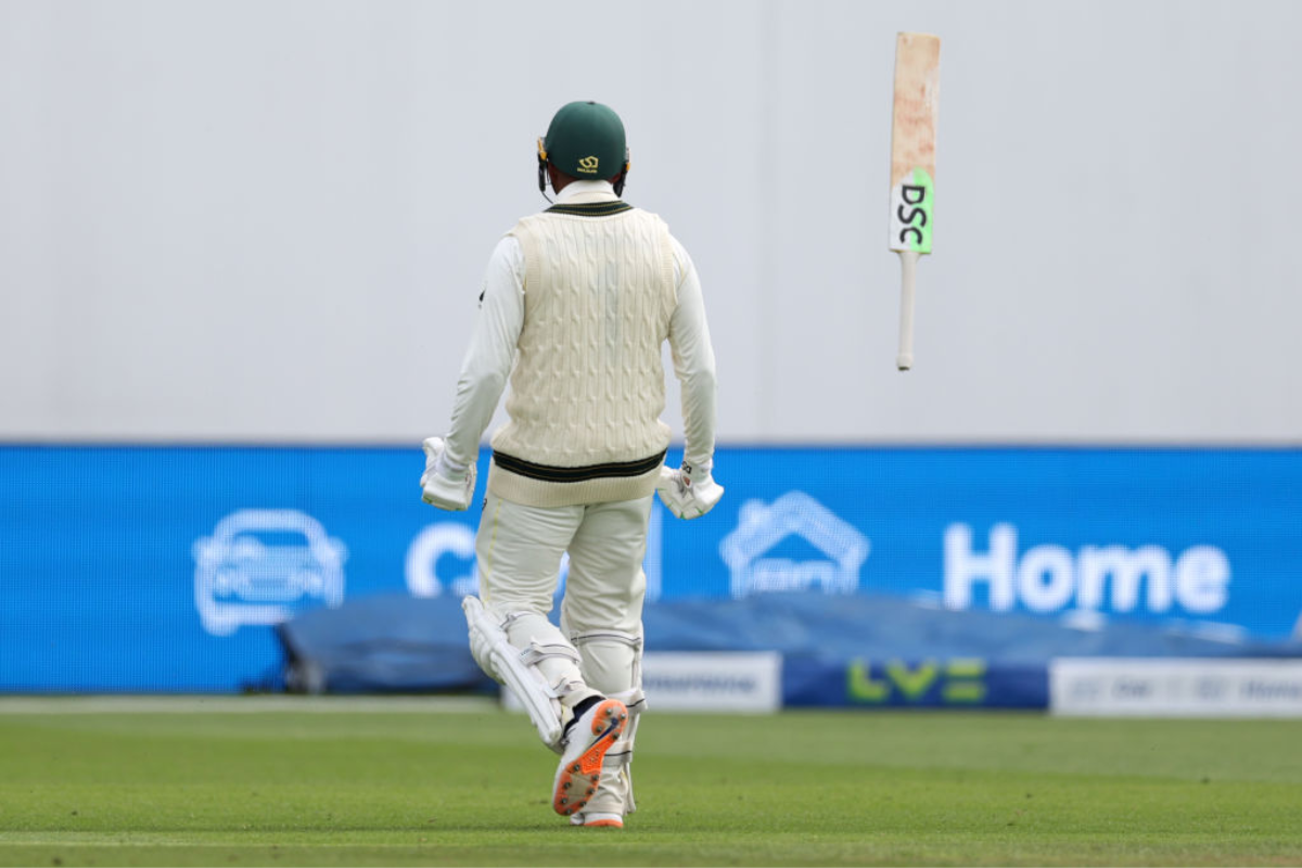 Usman Khawaja flung his bat in the air in celebration on completing his century