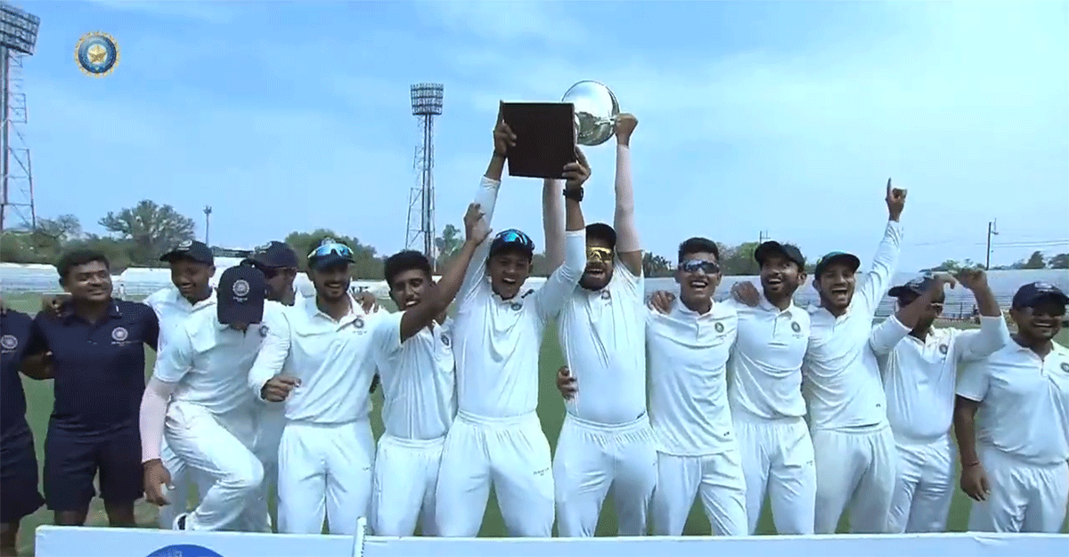 Rest of India players celebrate with the trophy after winning the Irani Cup on Sunday