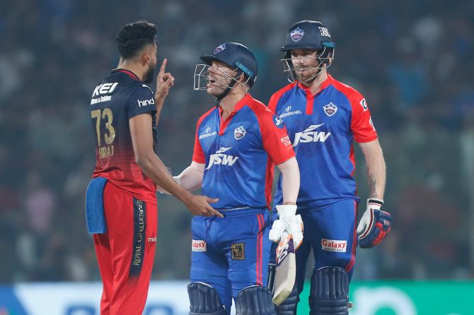Delhi Capitals skipper David Warner intervenes as  Royal Challengers Bangalore pacer Mohammed Siraj and Phil Salt get into a heated exchange during the IPL match in Delhi on Saturday.