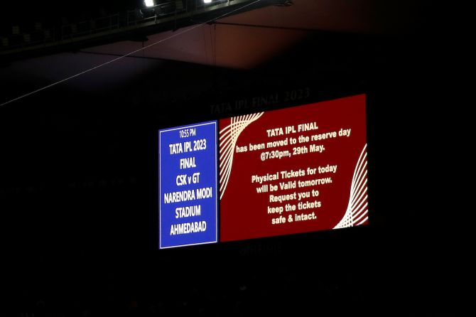 A big screen says the IPL final postponed for May 29
