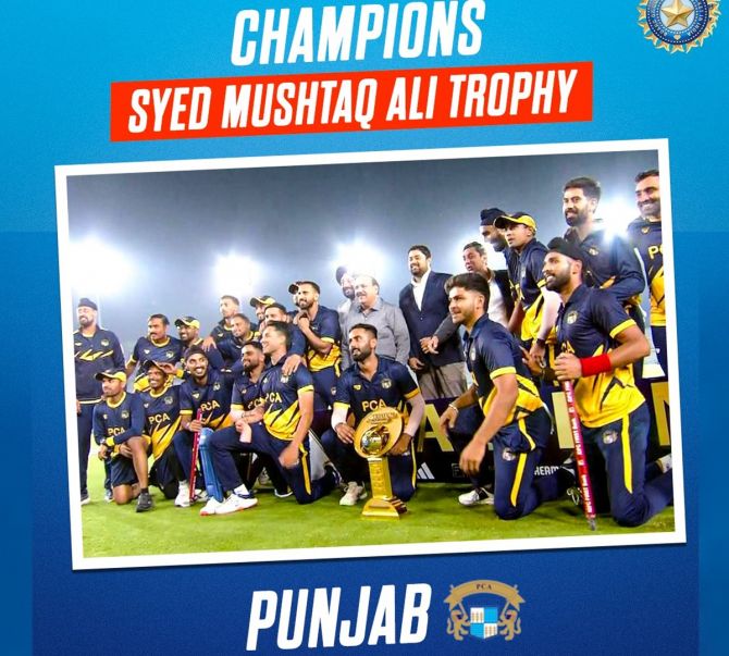 The victorious Punjab team celebrates with the Syed Mushtaq Ali trophy after beating Baroda in the final, in Mohali, on Monday