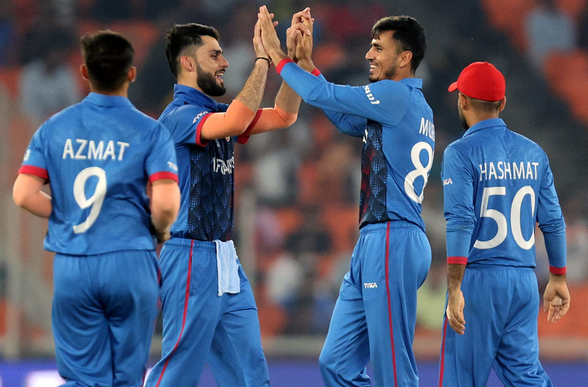 Mujeeb Ur Rahman rejoices with his Afghanistan teammates after taking the wicket of South Africa captain Temba Bavuma
