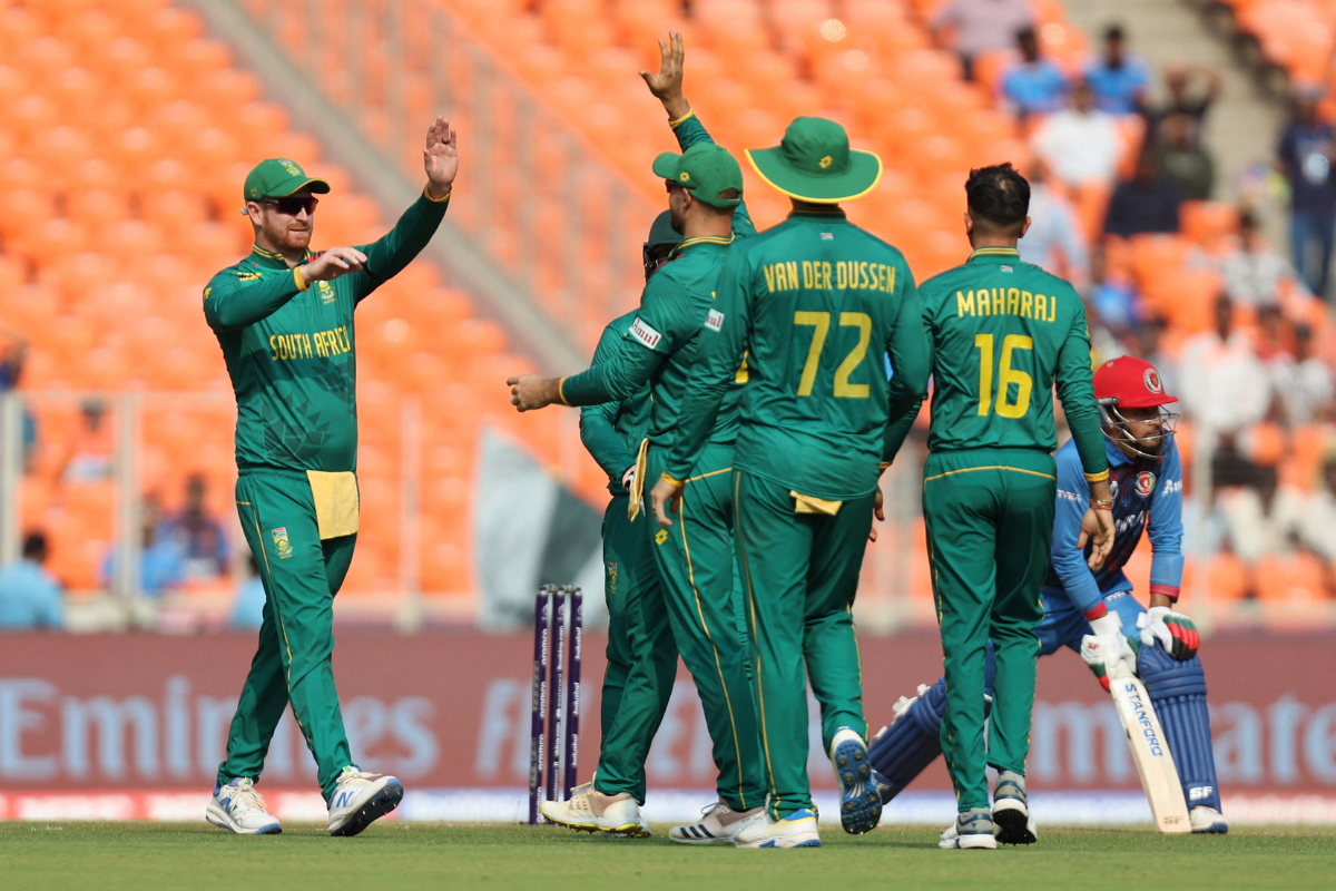 Gerald Coetzee celebrates with teammates after taking the wicket of Afghanistan opener Ibrahim Zadran.