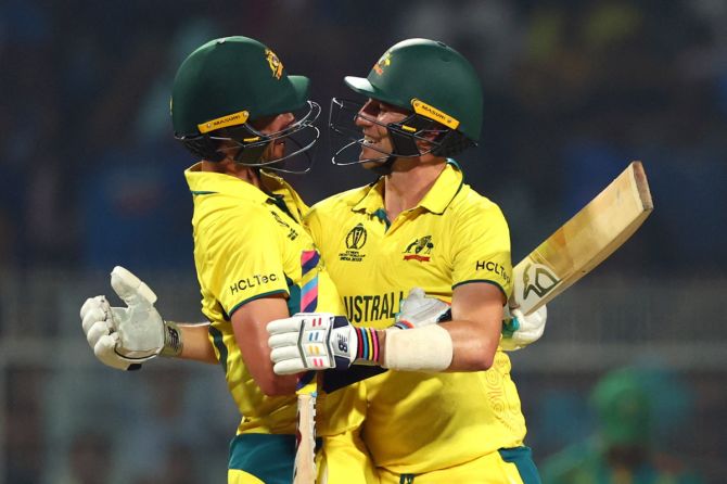 Australia's Pat Cummins and Mitchell Starc celebrate after defeating South Africa by three wickets at the Eden Gardens in Kolkata on Thursday