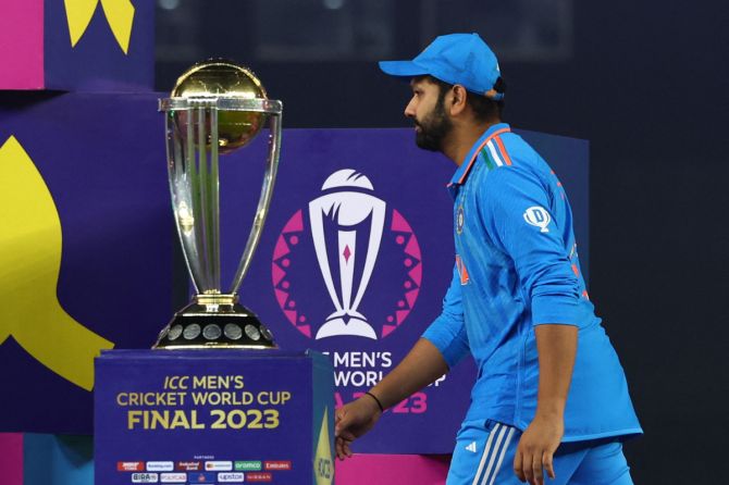 Indian captain Rohit Sharma walks past the ICC World Cup trophy after their loss in the final in Ahmedabad on Sunday