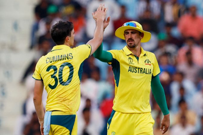 Australia's Pat Cummins celebrates with Mitchell Starc after taking the wicket of South Africa's Aiden Markram
