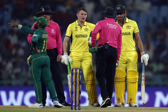 Australia's Marcus Stoinis speaks to the umpire after losing his wicket, caught by South Africa's Quinton de Kock off the bowling of Kagiso Rabada as Marnus Labuschagne looks on