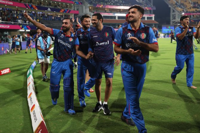 The Afghanistan team take a lap of honour around the stadium after their historic win