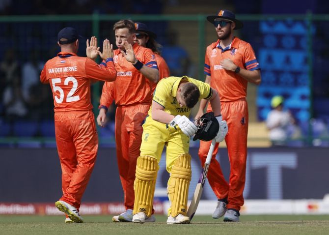 Netherlands' Logan van Beek celebrates with teammates after taking the wicket of Australia's Mitchell Marsh, caught by Colin Ackermann 