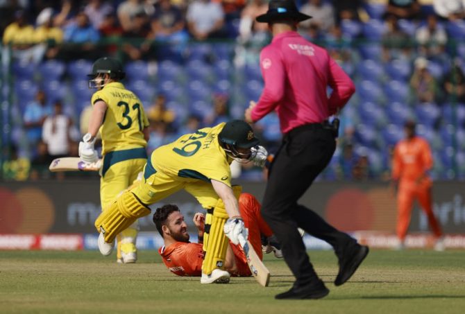 Australia's Steve Smith in action diving to avoid a run out as Netherlands' Paul van Meekeren looks on 