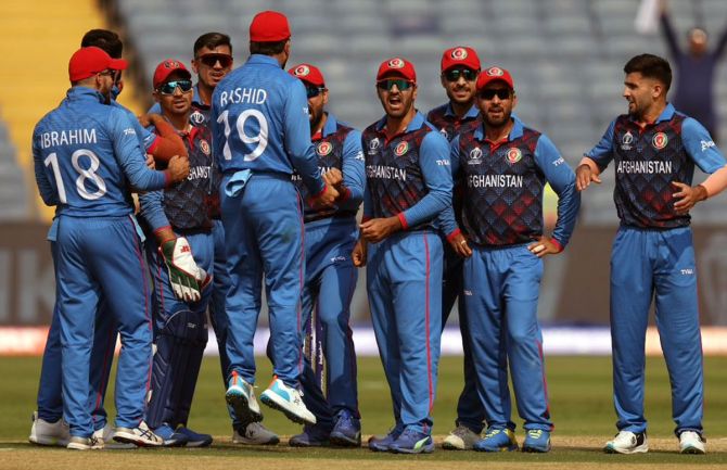 Afghanistan's players celebrate after Dimuth Karunaratne is given out on the review.