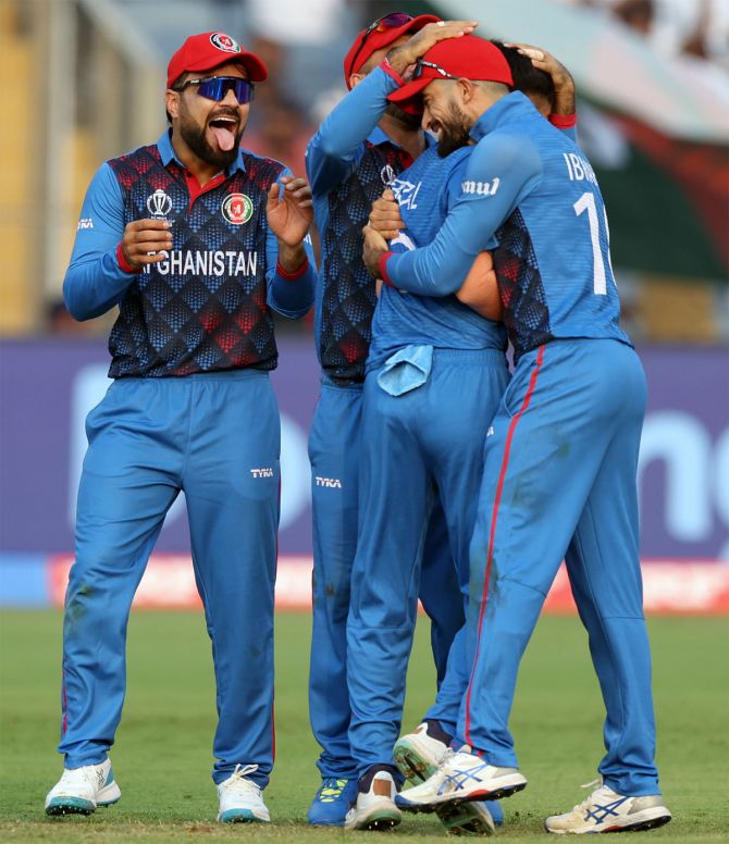 Afghanistan's players celebrate the wicket of Charith Asalanka.