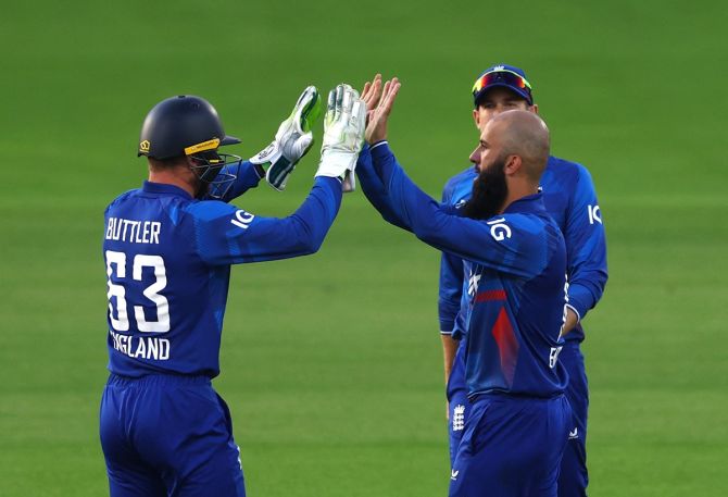 Moeen Ali celebrates with Jos Buttler after taking the wicket of Tom Latham.