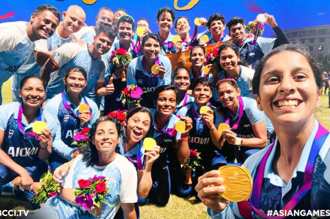 The jubilant Asian Games gold medal-winning women's cricket team and the coaching staff
