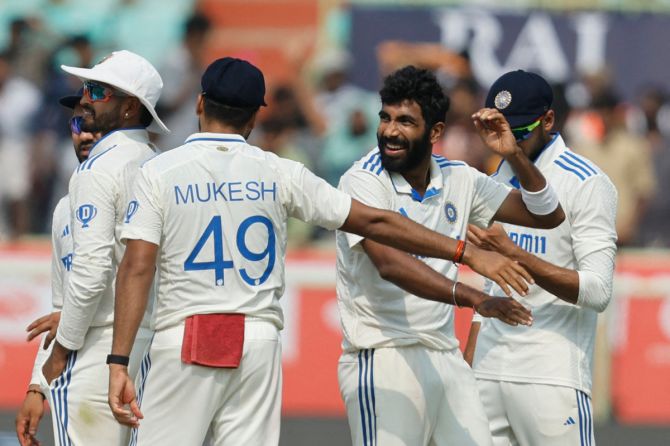 India's Jasprit Bumrah celebrates with teammates after taking the wicket of England's Joe Root