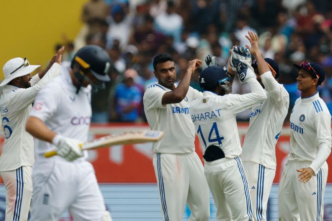 India's Ravichandran Ashwin celebrates with teammates after taking the wicket of England's Joe Root, caught out by Axar Patel