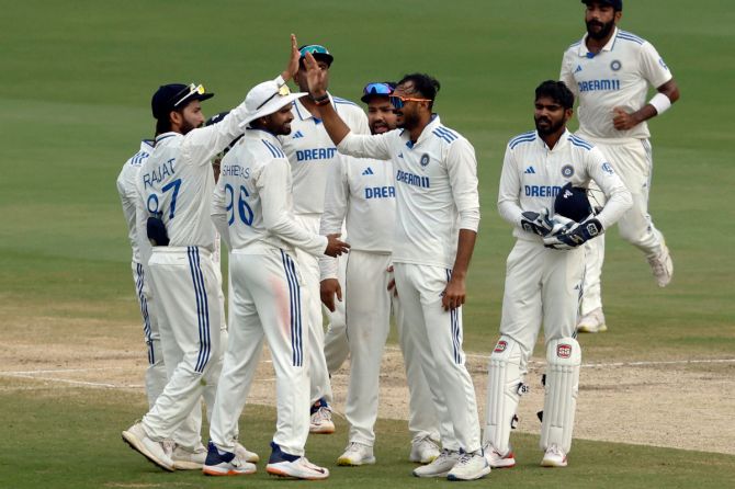 India's Axar Patel celebrates with teammates after taking the lbw wicket of England's Rehan Ahmed 