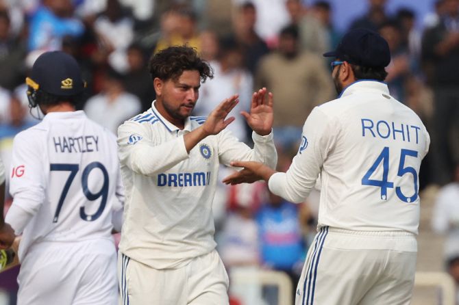 India's Kuldeep Yadav celebrates with Rohit Sharma after taking the wicket of England's Tom Hartley, caught out by Sarfaraz Khan