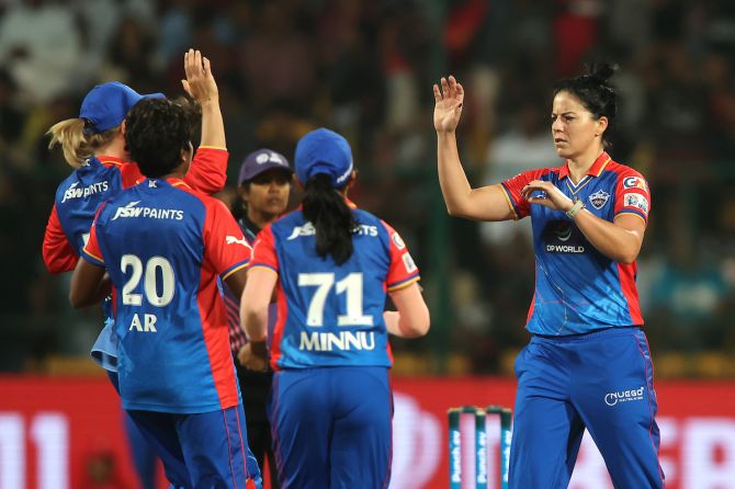 Delhi Capitals Marizanne Kapp is congratulated by teammates after for bowling out Royal Challengers Bangalore captain Smriti Mandhana