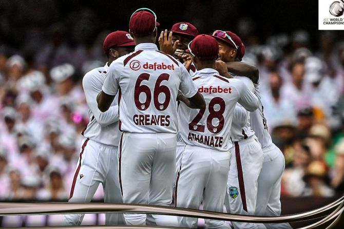 Windies players celebrate with Kemar Roach after taking early wickets