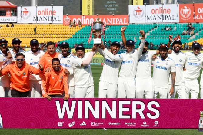India's Sarfaraz Khan and Dhruv Jurel lift the trophy and celebrate with teammates after winning the Test series