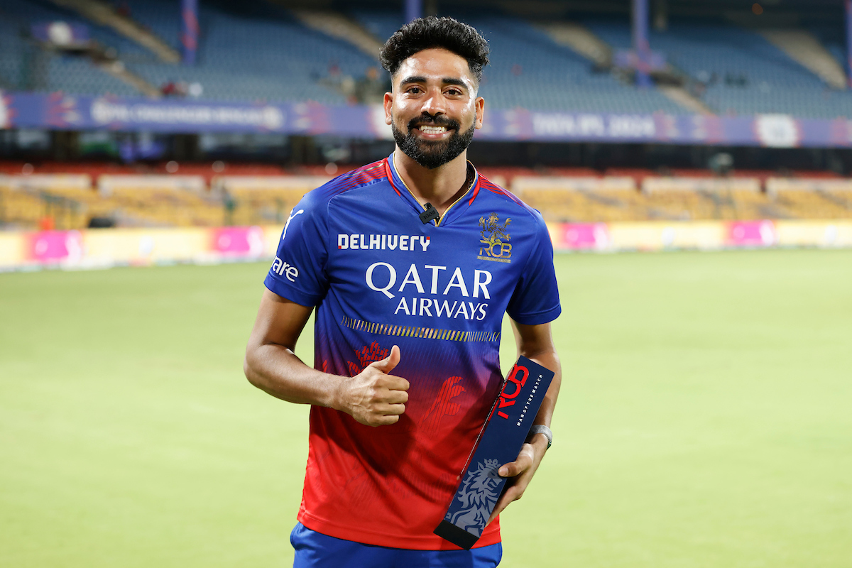 Pacer Mohammed Siraj celebrates with the 'Player of the match' award after guiding Royal Challengers Bengaluru to victory over Gujarat Titans in the IPL match in Bengaluru on Saturday.