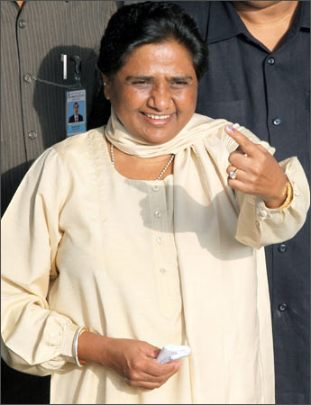 Mayawati gestures to media persons after casting her vote