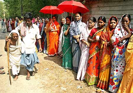 A woman is helped to a polling station to cast her ballot in Nandigram, about 150 km southwest of Kolkata, May 6, 2009