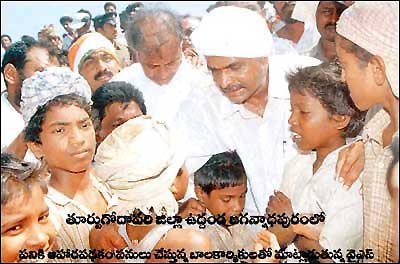 YSR talks to children at his road show during an election campaign