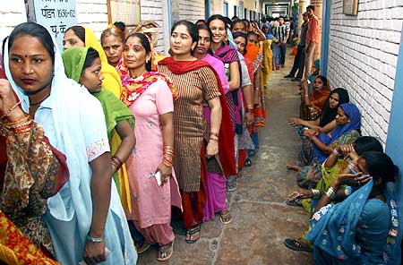 Voters line up to cast their ballots outside a polling station
