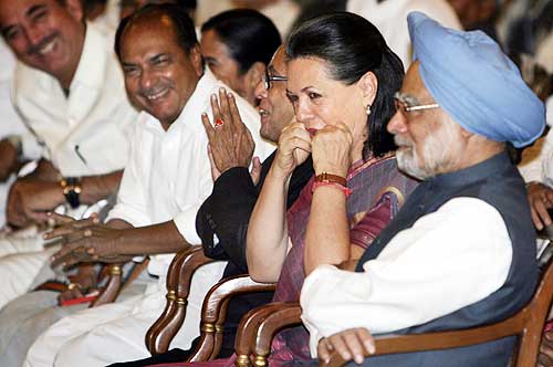 Sonia gestures as cabinet minister Ghulam Nabi Azad, Defence Minister A K Antony, Finance Minister Pranab Mukherjee and Prime Minister Manmohan Singh smile during an oath-taking ceremony