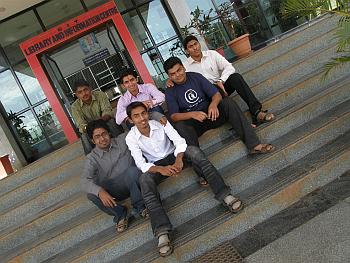 Manoj (seated first from left) and Sandeep (seated second from right) outside their office premises
