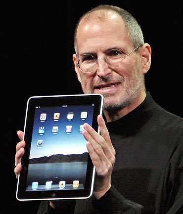 Apple Chief Executive Officer Steve Jobs holds the new iPad during the launch of Apple's new tablet computing device in San Francisco, California, January 27, 2010.