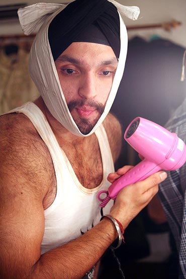 Gurneet Singh sets his beard with a blow dryer
