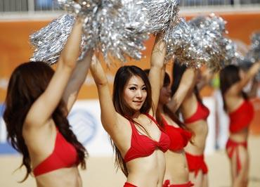 Cheerleaders perform a routine during the quarter-finals of the beach volleyball event at the 16th Asian Games in Guangzhou