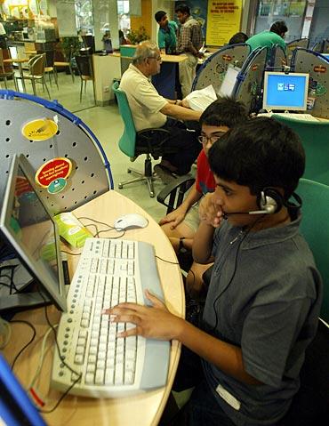 hildren play computer games at a high-speed broadband internet cafe in Kolkata.