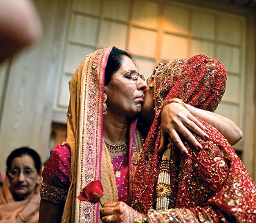 A bride hugs her mother after the wedding ceremony in Kuala Lumpur