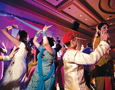 In Bangkok, family and friends dance at a sangeet ceremony