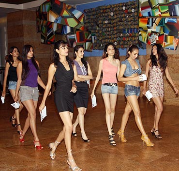 Would-be models strut their stuff in the hotel lobby