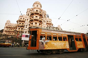 A tram passes beside a heritage building in the eastern Indian city of Kolkata