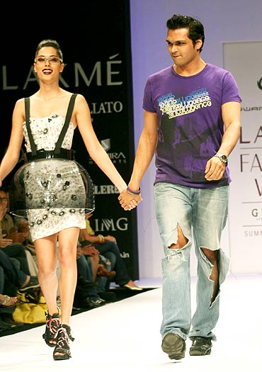 Swapnil Shinde walks the ramp with a model
