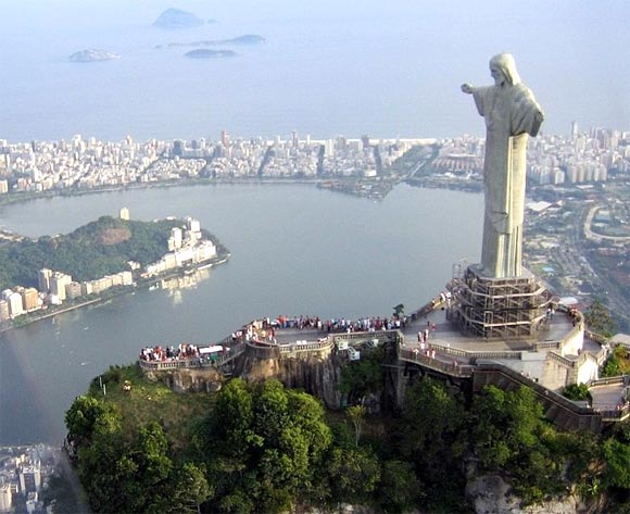 Cristo Redentor statue on top of Corcovado, a mountain towering over Rio de Janeiro. In the background the Ipanema and Leblon beaches separate the lagoon from the Atlantic Ocean