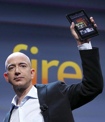 Amazon CEO Jeff Bezos holds up the new Kindle Fire at a news conference during the launch of Amazon's new tablets in New York, September 28, 2011.