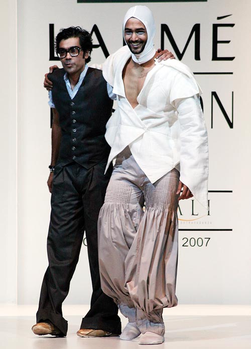 Arjun Saluja (left) with a model in one of his creations