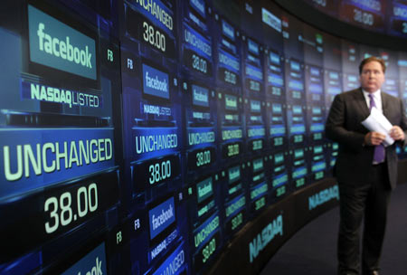A reporter waits for the share price of Facebook to start trading at the Nasdaq stock market moments before it went public on May 18, 2012 in New York, United States. The social network site began trading after 11:30 a.m. with shares jumping 13% to $43 before quickly falling. On Thursday Facebook priced 421 million shares at $38 each. Facebook, a Menlo Park, California based company, will have a valuation exceeding $100 billion.
