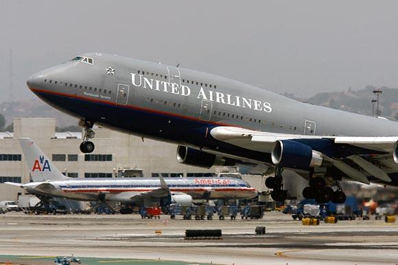 A United Airlines Boeing 747-422 jet flies pas an American Airlines jet upon take-off at Los Angeles International Airport (LAX) on June 4, 2008 in Los Angeles, California. Because of record fuel prices, the nation?s second largest air carrier announced that it will ground its entire fleet of 94 gas-guzzling Boeing B737s and six 747s. United will also cut up to 1,100 more jobs and downsized it domestic capacity to make up for higher fuel costs.