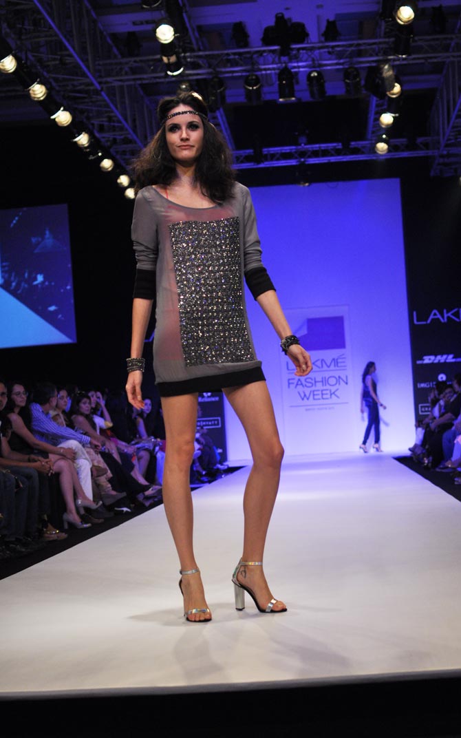 A model presents a cocktail dress by Anushka Khanna